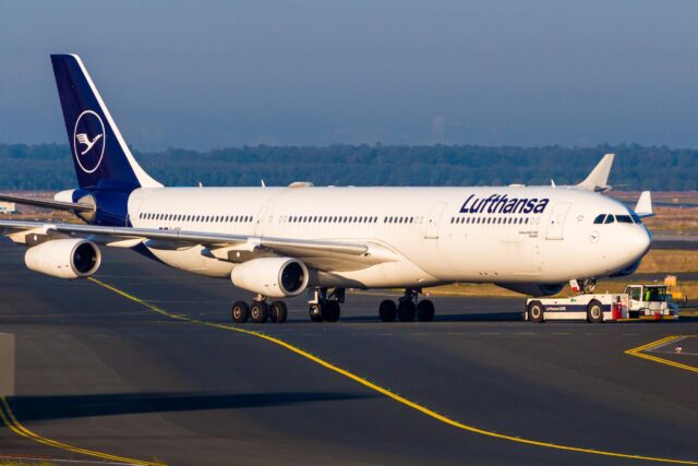 Lufthansa Airbus A340-300 being towed on ground at Frankfurt Airport.