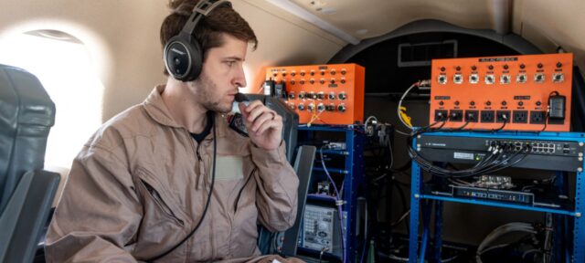 A NASA researcher monitors experimental communications equipment on NASA’s Pilatus PC-12 during a flight test over NASA’s Glenn Research Center in Cleveland
