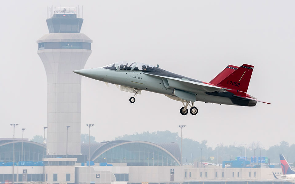 The T-7A Red Hawk flying past a control tower 2